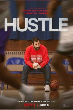 a man sitting on a bench in front of a poster for the movie hustle