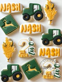 decorated cookies are arranged in the shape of tractors