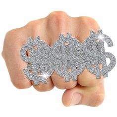 a hand holding two pieces of silver glittered broochies in the shape of gears