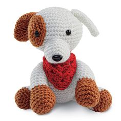 a crocheted dog with a red bandanna around it's neck sitting down