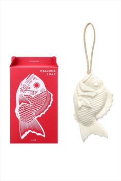 a white fish ornament next to a red box