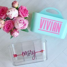 two personalized acrylic boxes with pink flowers and one carrying a blue box