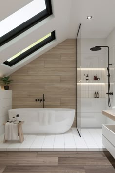 an attic bathroom with skylights and white tile flooring, along with a freestanding bathtub