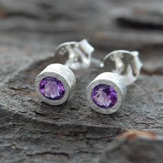 Simple, elegant and full of class, these Amethyst February Birthstone 18kt Rose Gold plated Silver Stud Earrings feature hand-faceted Amethyst gemstones set into gently textured 18kt Rose Gold plated Silver surrounds. Elegant and understated, these earrings are ideal for a cocktail party or general everyday wear. As the birthstone for February, Amethyst makes a great gift for those whose birthday falls in that month. Made from : 18kt Gold and Rose Gold plated Sterling Silver and Amethyst Measurements: Stud diameter: approx. 6 mm Pendant diameter: approx. 6mm Chain Length 16 inches plus 2" extender chain, a total of 18 inches Silver Round Earrings, February Birthstone Necklace, Organic Earrings, Jewellery Photography, Amethyst Birthstone, Amethyst Studs, Gemstone Stud Earrings, Sterling Silver Stud Earrings, Jewellery Accessories