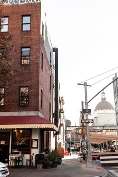 an old brick building on the corner of a street