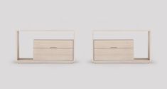 two white wooden drawers sitting next to each other