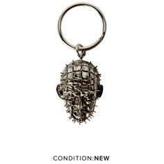 a metal keychain with an image of a human head on it's side