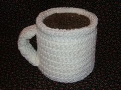 a crocheted coffee cup is sitting on the table