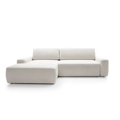 a white couch sitting on top of a white floor