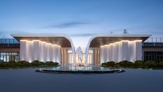 an architecturally designed building is lit up at night