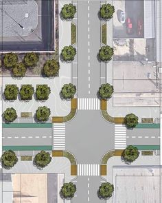 an aerial view of a street intersection with trees