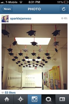 an image of graduation decorations hanging from the ceiling in a school hallway with pictures on it