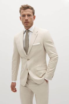 Fulfilled by our friends at SuitShop Embody laid-back elegance in the light tan suit. This mod, sandy shade with visible woven texture throughout is designed to suit you from sunny celebrations to the office, candlelit dinners, and everywhere in between. The mens tan suit is crafted from signature Eco Stretch fabric, sure to keep you cool and comfortable through it all.