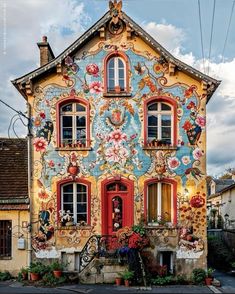 an old house painted with flowers and birds