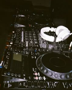 dj equipment including headphones and turntables on a table