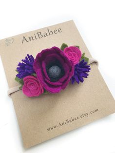 a purple flower with green leaves is on top of a piece of paper that says anibabeee