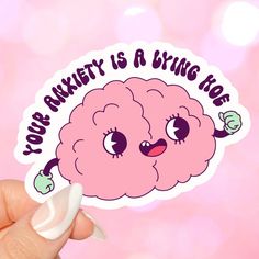 someone holding up a sticker with an image of a brain