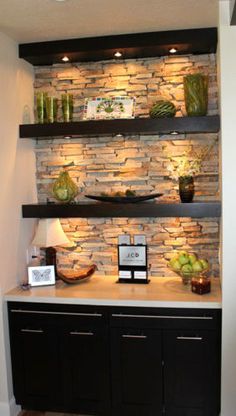 a room with stone walls and shelves on the wall, along with other items in it