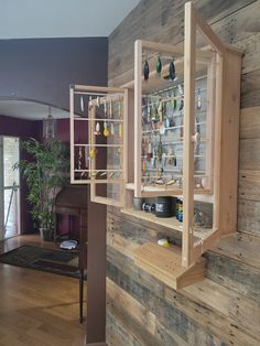 a room with wooden walls and shelves filled with various items on the wall next to a piano