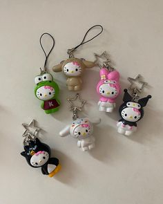 hello kitty keychains are lined up on a table