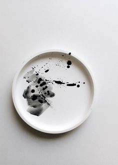 a white plate with black spots on it