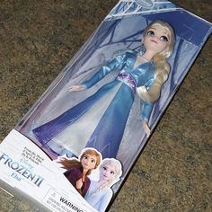 the frozen princess doll is in its box on the counter top, and it's ready to be opened