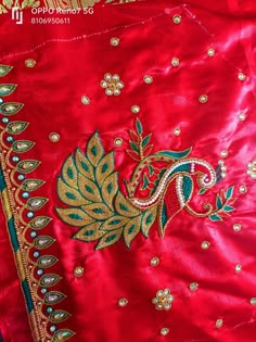 an embroidered red jacket with gold and blue details on it's chest, in the middle