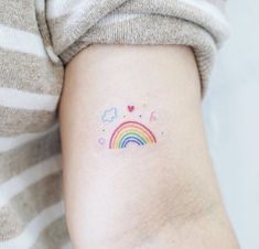 a person with a rainbow tattoo on their arm