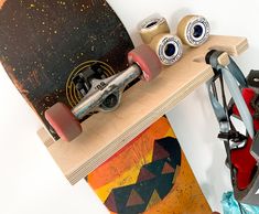 a skateboard sitting on top of a wooden shelf next to other skateboards and accessories