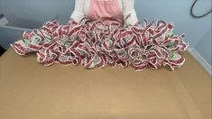 a woman sitting at a table with some candy canes in front of her on it