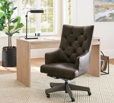 a brown office chair sitting in front of a desk with a potted plant on it