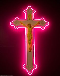 a neon lit cross with jesus on it