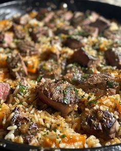 a pan filled with meat and rice on top of a table