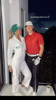 a man and woman standing next to each other in front of a building at night