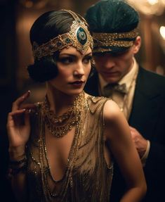 a man and woman dressed up in flappers, garb and headpieces