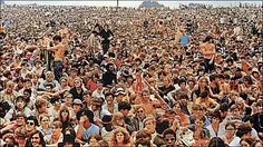 a large group of people standing in front of each other at a music festival or concert