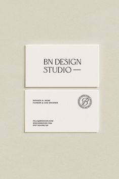 two business cards on top of each other with the words bn design studio in black and white