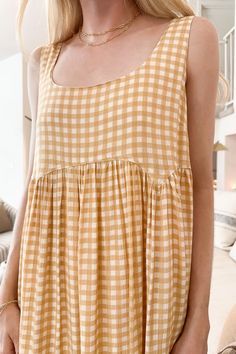 Just picture this dress billowing in the wind! The Poppy Gingham Dress is flowy and perfect for summer! Featuring a gingham pattern, yellow and off white colors, lightweight feel, babydoll silhouette, lightweight feel, lining throughout and a true to size fit. Style this gingham dress with nude heels and a neutral bag! Details & Sizing Gingham pattern Yellow and off white colors Babydoll silhouette Lightweight feel Lining throughout True to size fit fit Gabriella is wearing a size S Fabric 100% Gingham Babydoll Dress, Neutral Bag, Farm Clothes, Bag Details, Gingham Pattern, White Colors, Gingham Dress, Picture This, Nude Heels