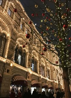 christmas lights adorn the facade of an old building