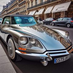 a silver car parked on the side of a street