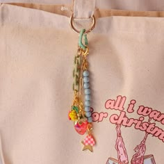 a close up of a bag with beads and charms hanging from it's side