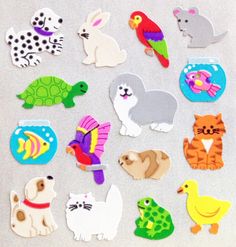 various cutouts of different animals and birds on a white surface with one animal looking at the camera