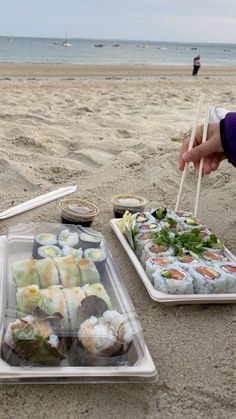 sushi platters on the beach with chopsticks