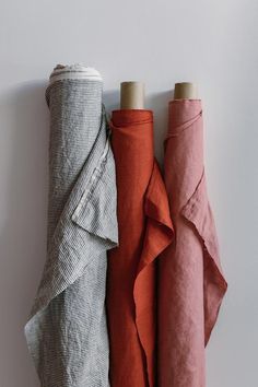 three different colored linens are lined up on the wall