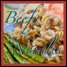 a plate with pasta, asparagus and beef on it that says beefy noodles