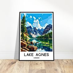 a poster with the words lake agnes in canadian on it, sitting on a wooden floor