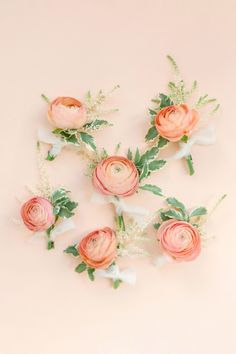 pink flowers and greenery on a pale background