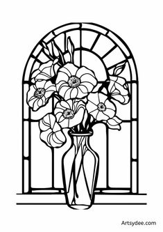 a vase filled with flowers next to a stained glass window