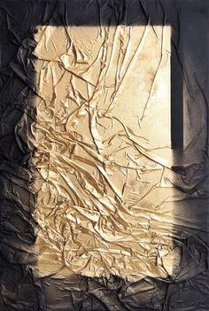 an abstract painting with gold paint on black paper