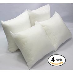 four white pillows stacked on top of each other